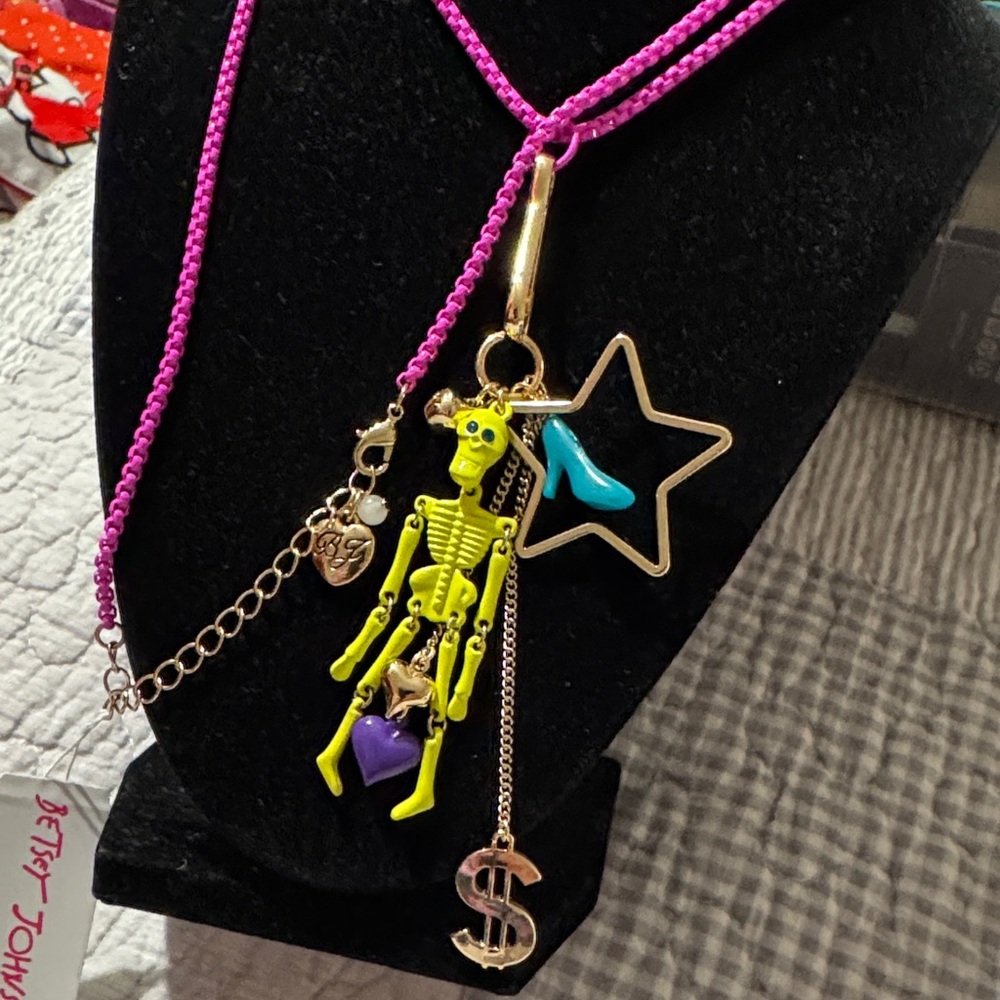 Betsey Johnson XL long skeleton charm necklace on bright fuschia colored chain